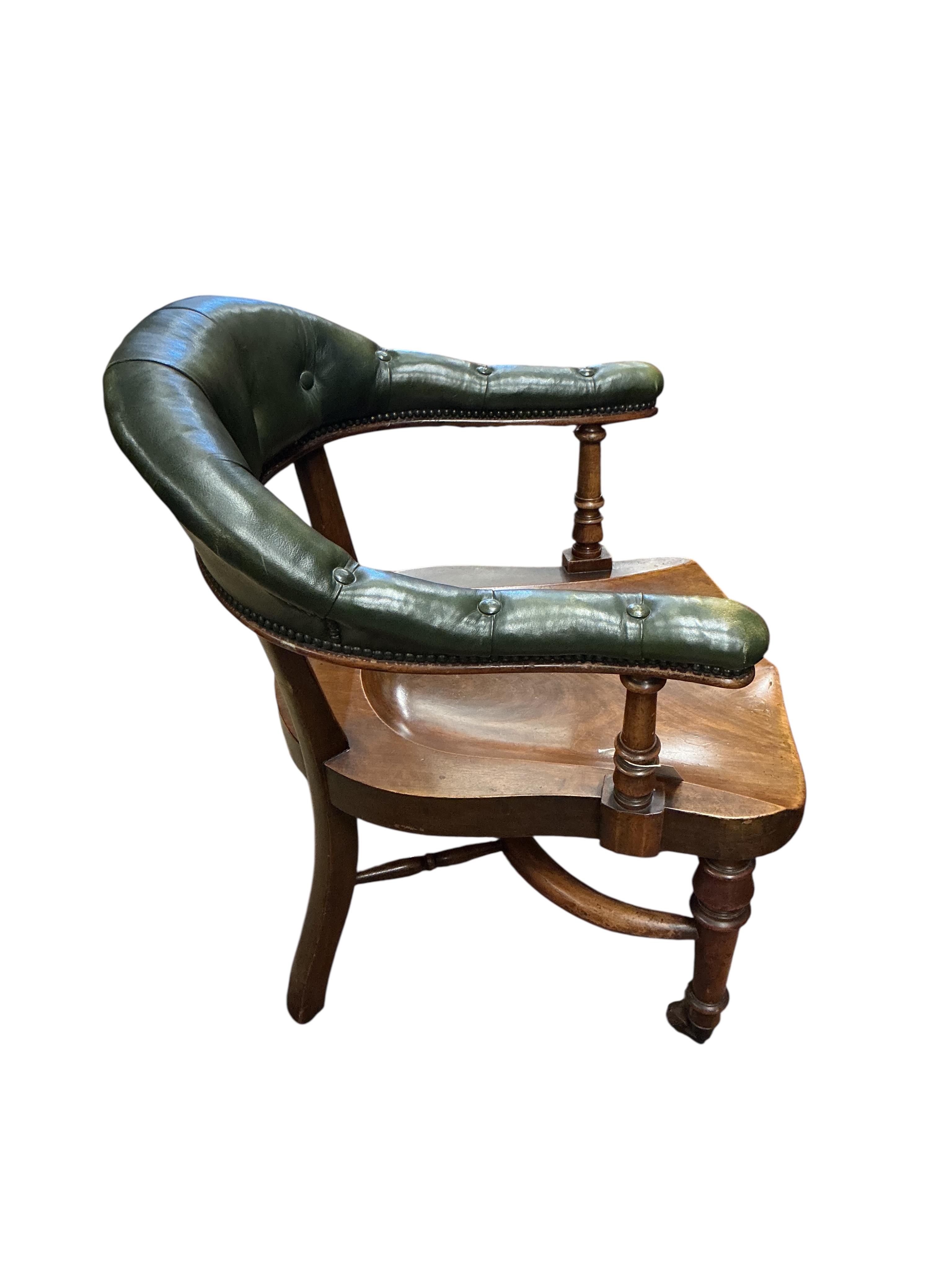 A Victorian mahogany and green buttoned leather desk chair, width 62cm, depth 60cm, height 85cm